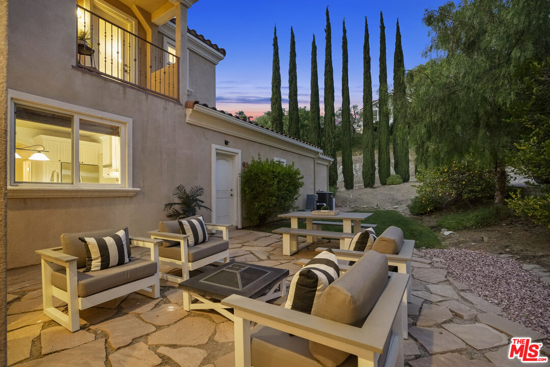 969 Crown Hill Drive Simi Valley, CA 93063 - Photo 48 of 62 a view of a patio with couches table and chairs and potted plants