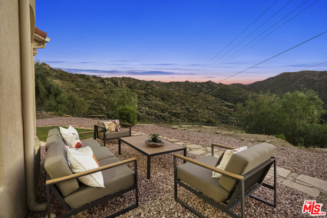969 Crown Hill Drive Simi Valley, CA 93063 - Photo 55 of 62 a view of a terrace with couches and wooden fence
