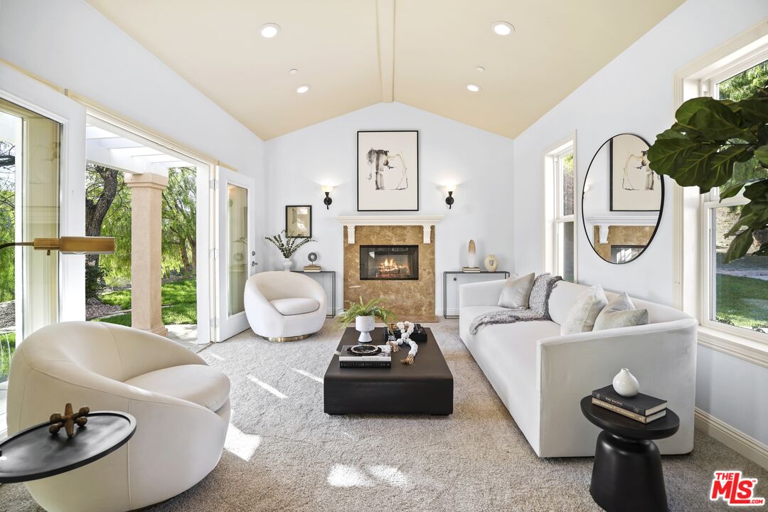 969 Crown Hill Drive Simi Valley, CA 93063 - Photo 9 of 62 a living room with furniture fireplace and a large window