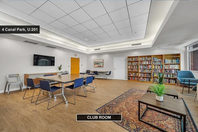 a living room with furniture a computer and a table