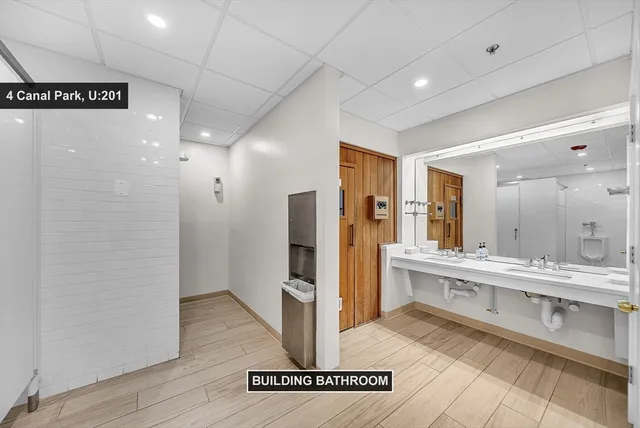 a large bathroom with a glass door shower and sink