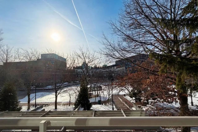 a kitchen with white cabinets stainless steel appliances and a refrigerator