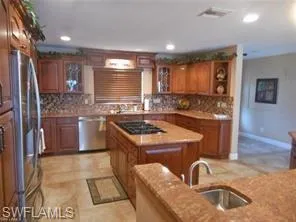 a kitchen with a sink stove and cabinets