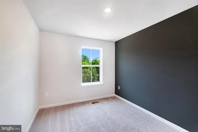 a bathroom with a granite countertop bathtub shower sink vanity and toilet