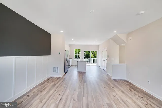 a view of a living room a window and wooden floor