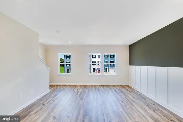 a view of a living room hardwood floor and a kitchen