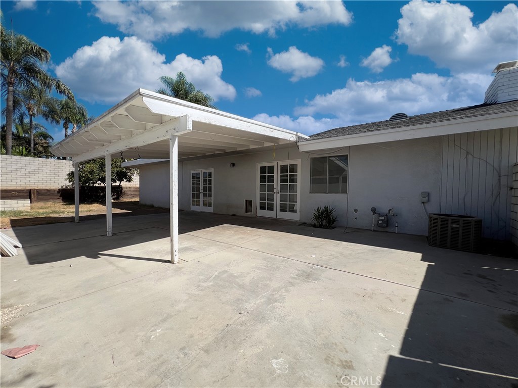 22574 Kentfield Street Grand Terrace, CA 92313 - Photo 19 of 22 a patio with a table and chairs and potted plants