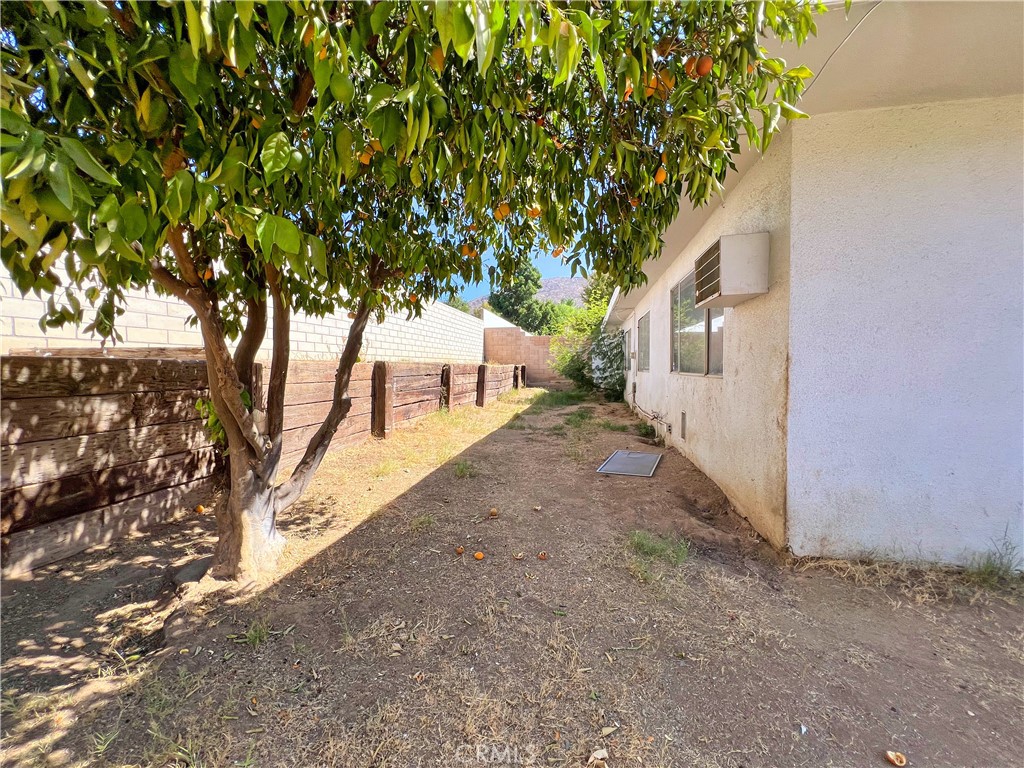 22574 Kentfield Street Grand Terrace, CA 92313 - Photo 21 of 22 a view of a yard with large tree