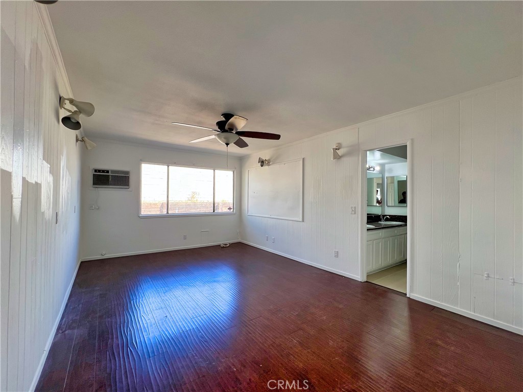 22574 Kentfield Street Grand Terrace, CA 92313 - Photo 8 of 22 an empty room with wooden floor chandelier and windows