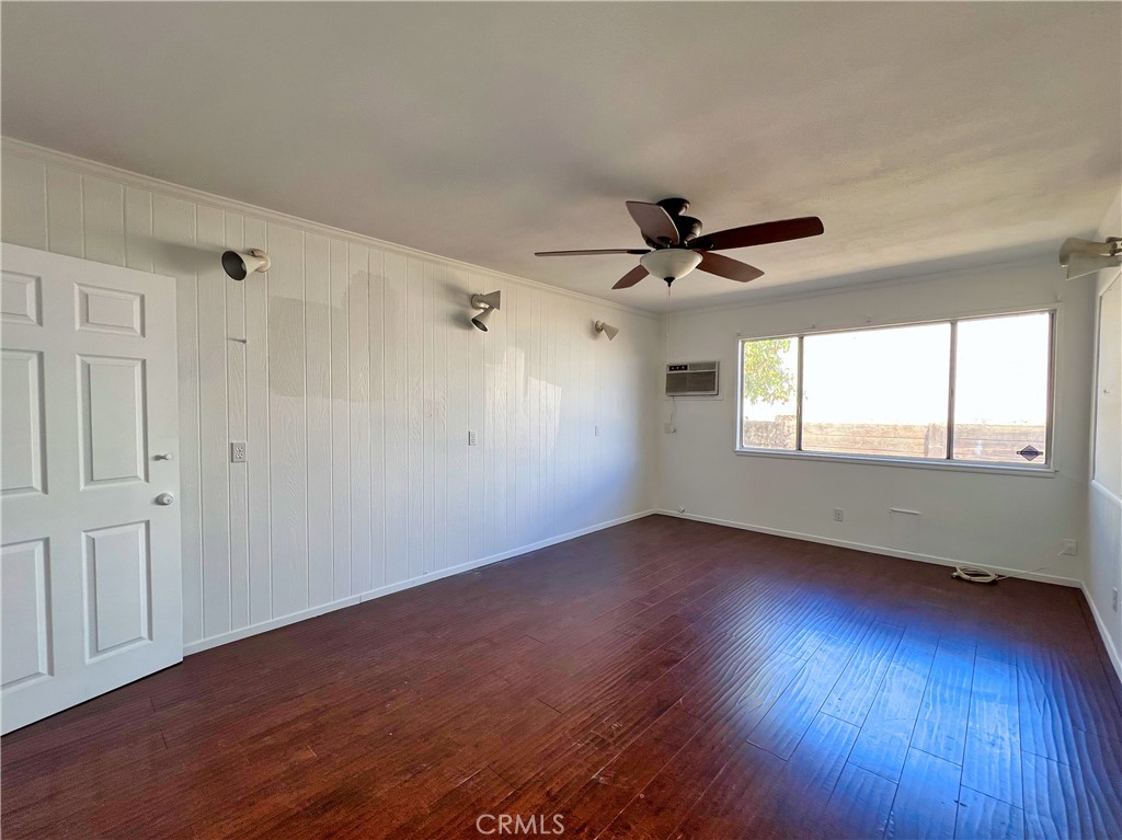 22574 Kentfield Street Grand Terrace, CA 92313 - Photo 9 of 22 an empty room with wooden floor fan and windows