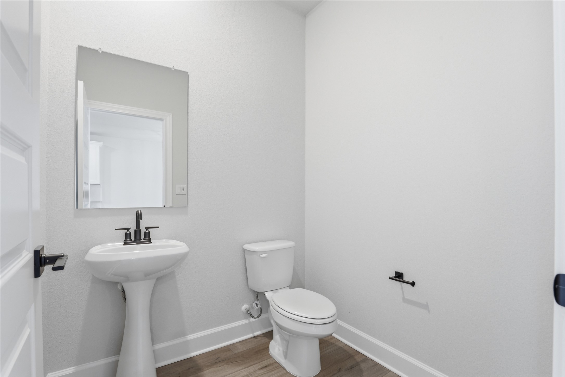 9320 Gladsome Path Manor, TX 78653 - Photo 18 of 34 a bathroom with a sink a mirror and a toilet