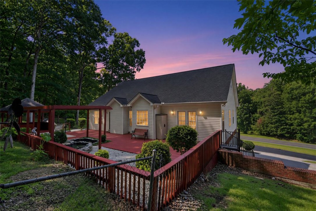 1052 Madden Bridge Road Central, SC 29630 - Photo 45 of 50 A spacious wooden deck extends from the back of the home amidst mature trees.