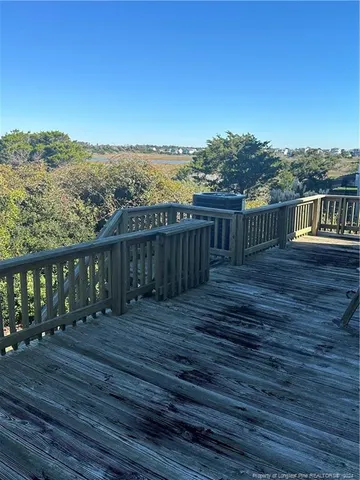 a view of a balcony with wooden floor and city view