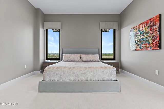 a bedroom with a bed and a painting on the wall