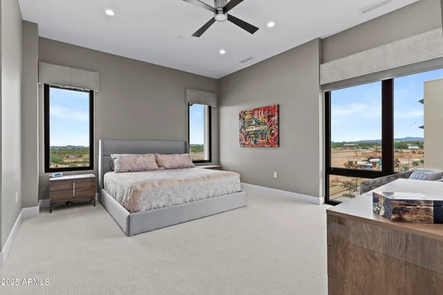 a spacious bedroom with a large bed and a window