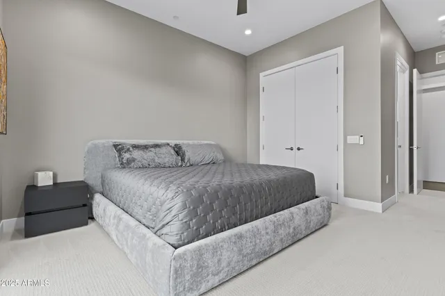 a spacious bedroom with a bed and couch