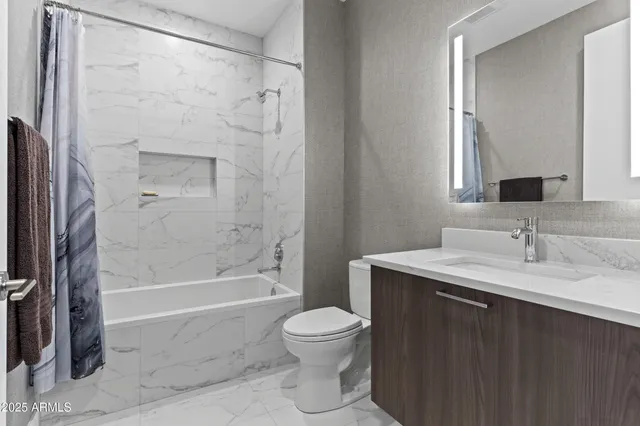a bathroom with a granite countertop sink toilet a shower and a mirror