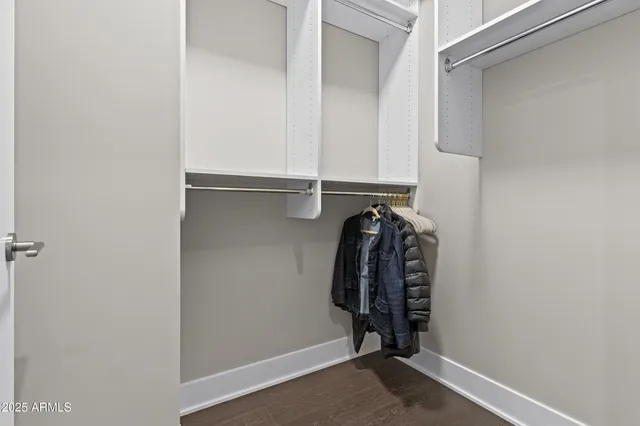 a view of walk in closet with clothes