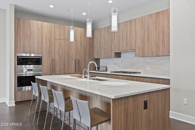a kitchen with a table chairs sink and cabinets