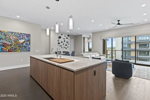 a kitchen with granite countertop a sink and a stove top oven