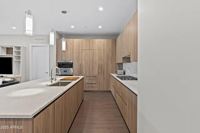 a kitchen with stainless steel appliances granite countertop a sink and stove
