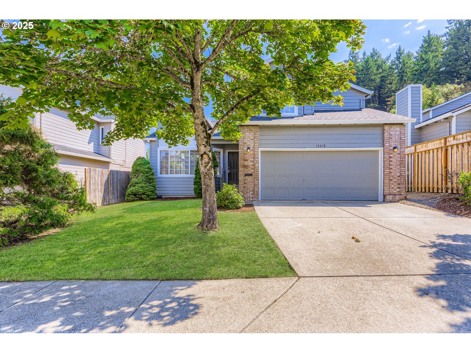 a front view of a house with a yard and a garage