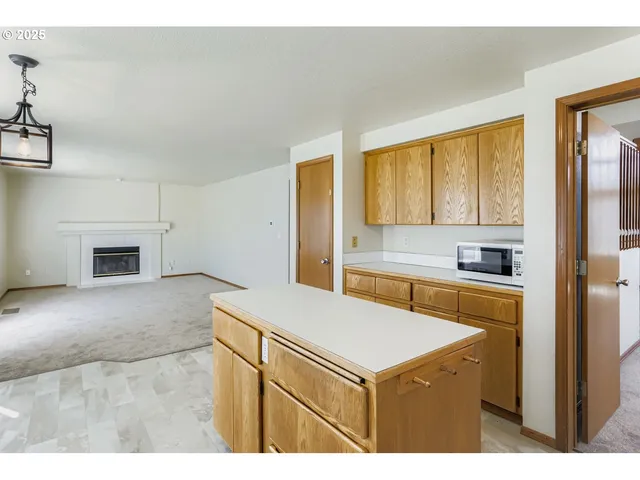 a kitchen with granite countertop a sink stove and refrigerator