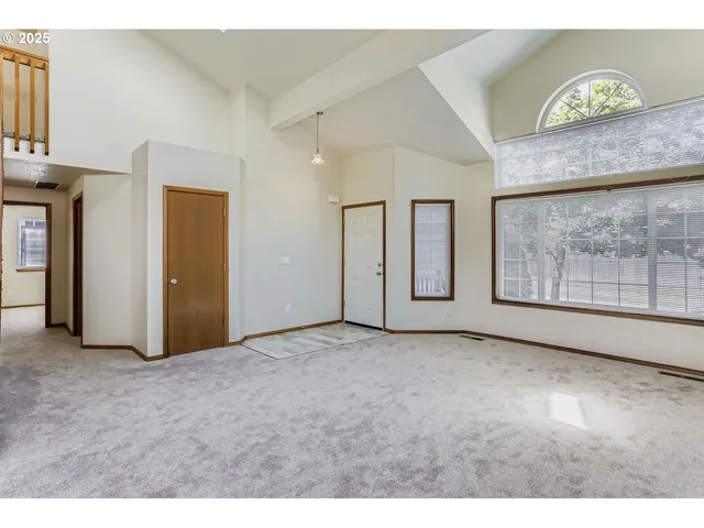 a view of an empty room with windows