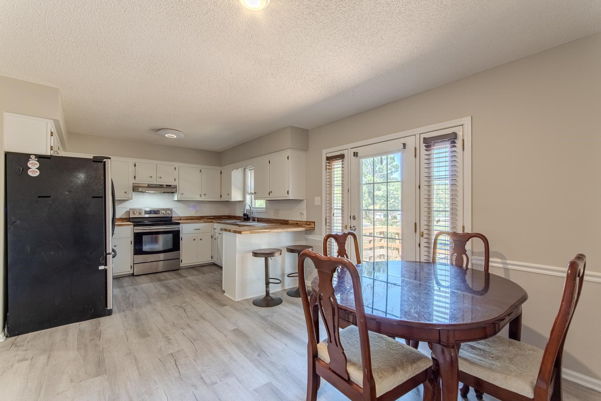 606 Duren Drive Adamsville, TN 38310 - Photo 12 of 40 a view of a dining room with furniture window and wooden floor