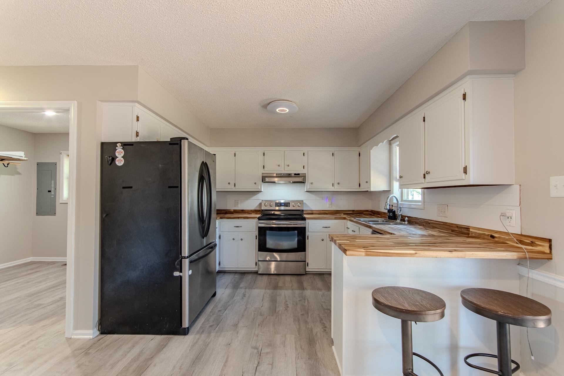 606 Duren Drive Adamsville, TN 38310 - Photo 13 of 40 a kitchen with granite countertop a refrigerator stove and sink