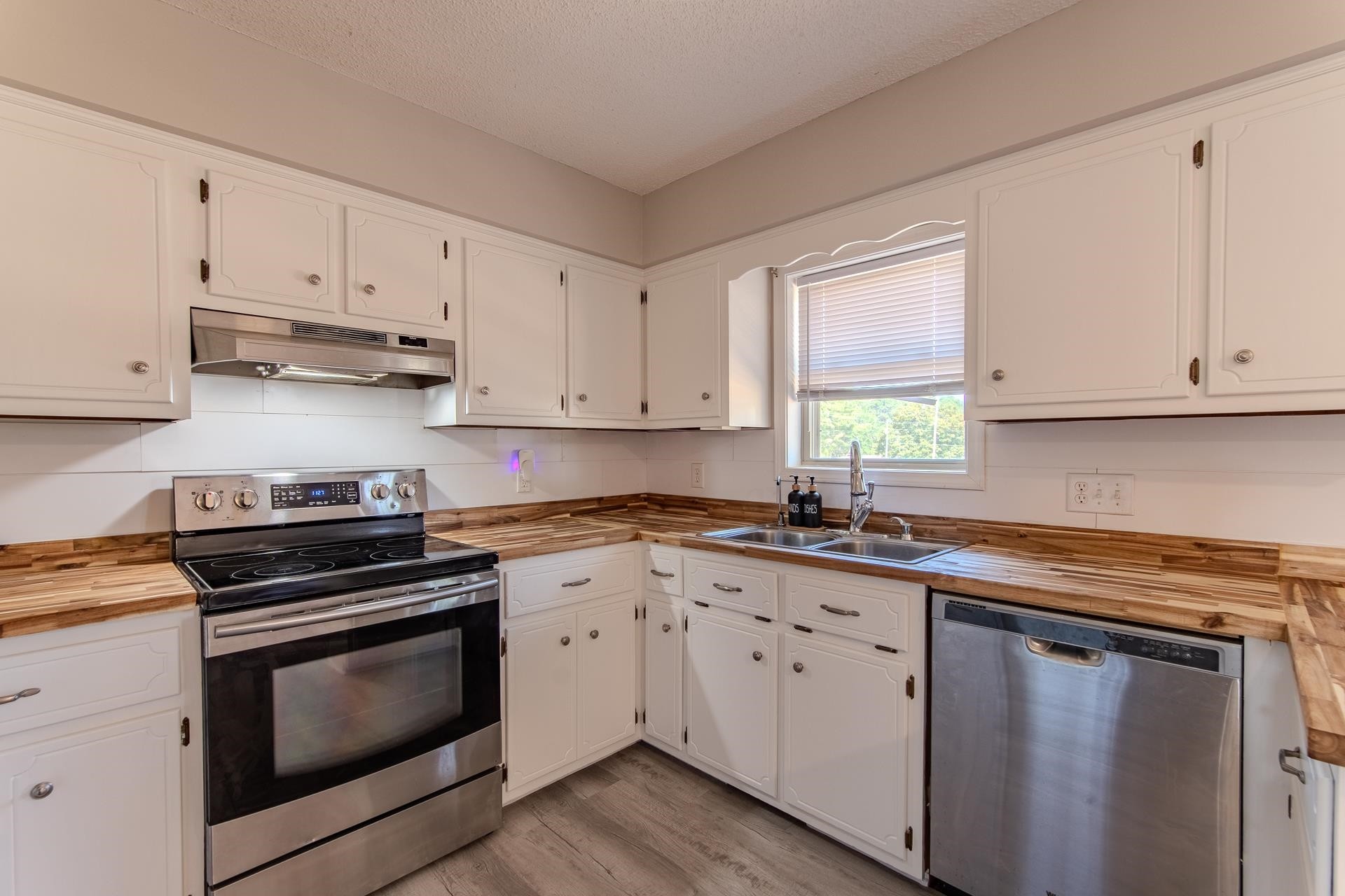 606 Duren Drive Adamsville, TN 38310 - Photo 15 of 40 a kitchen with cabinets appliances a sink and a window