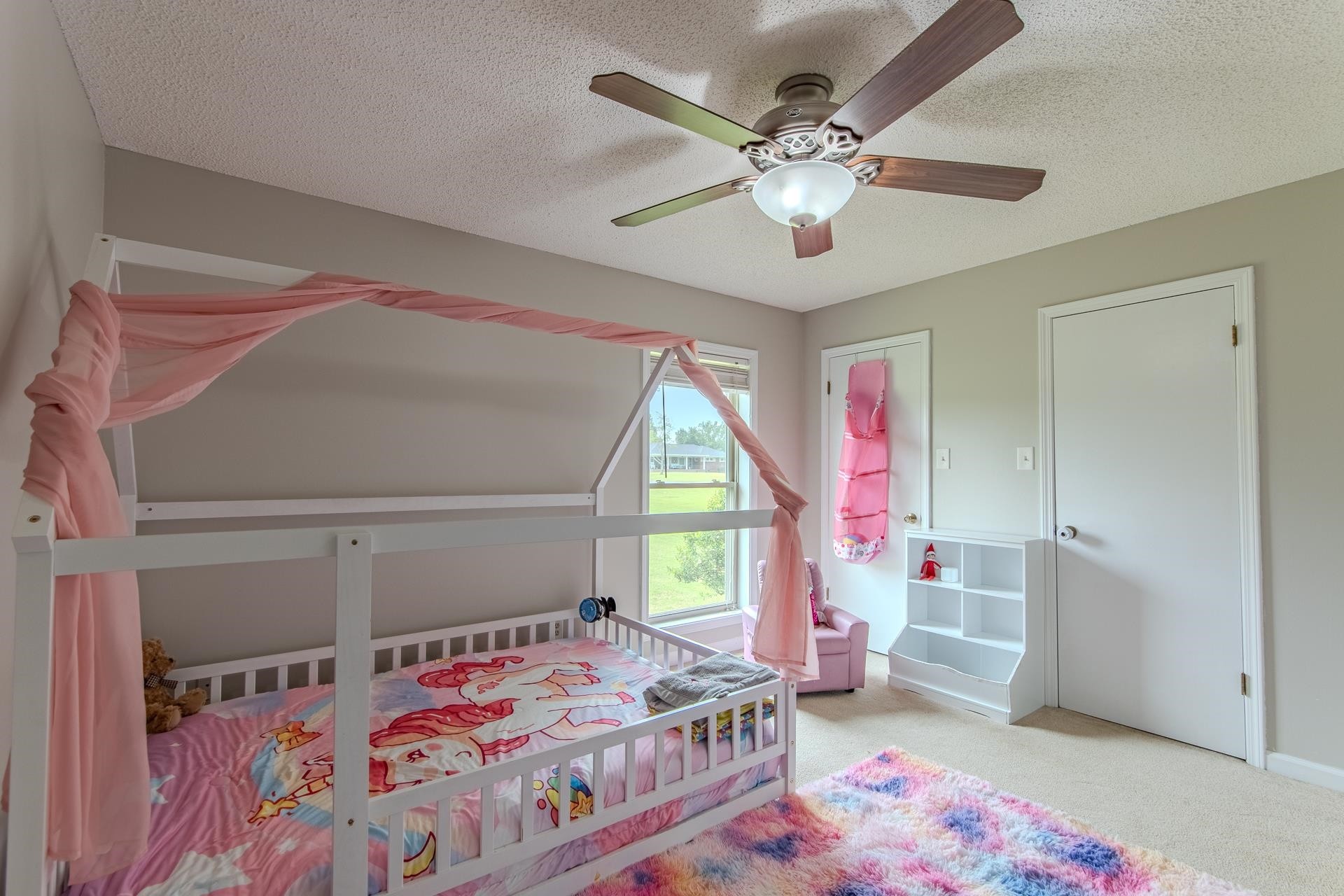 606 Duren Drive Adamsville, TN 38310 - Photo 21 of 40 a bedroom with a bed and a chandelier