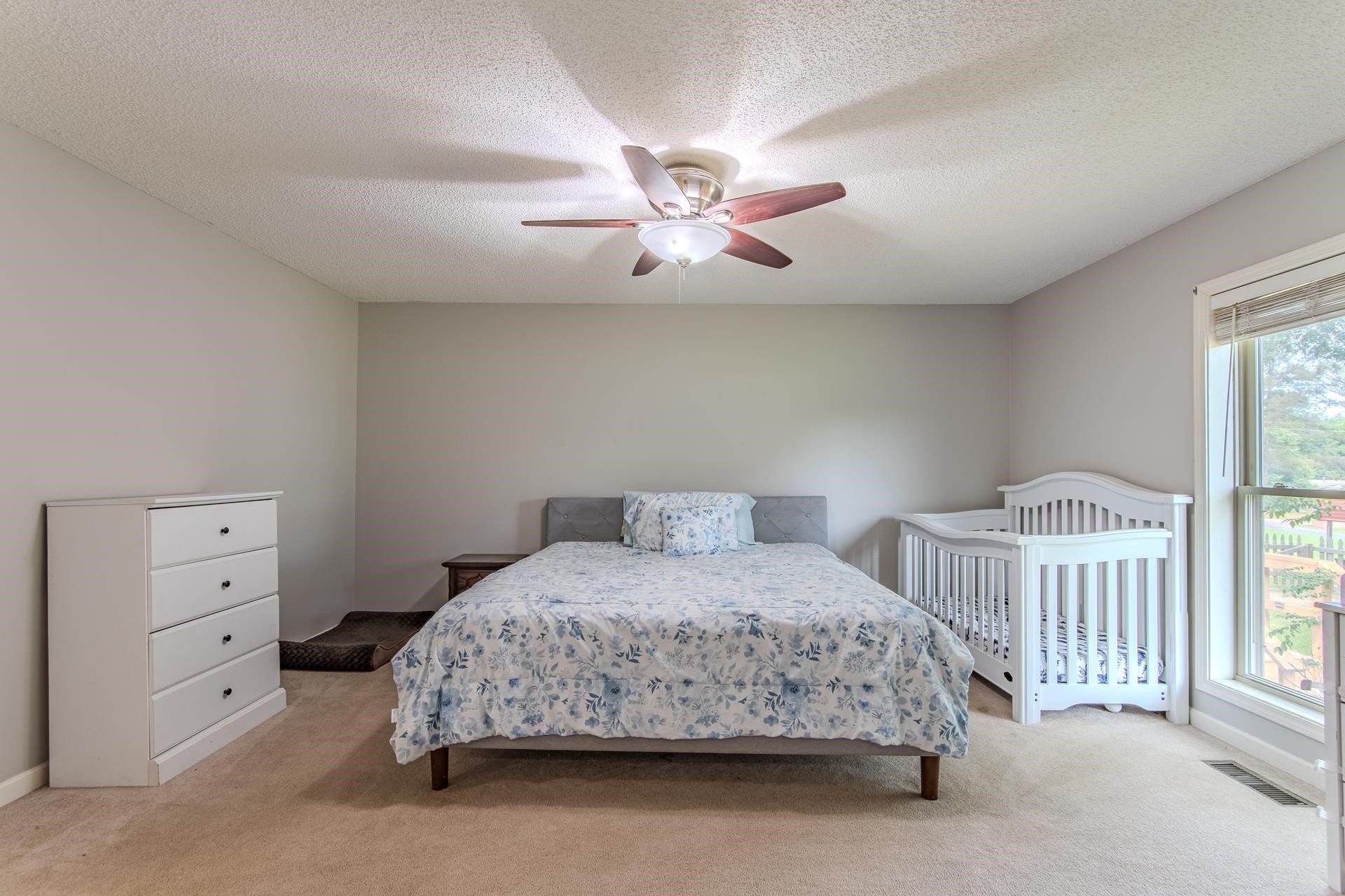 606 Duren Drive Adamsville, TN 38310 - Photo 24 of 40 a bedroom with a bed and a chandelier fan