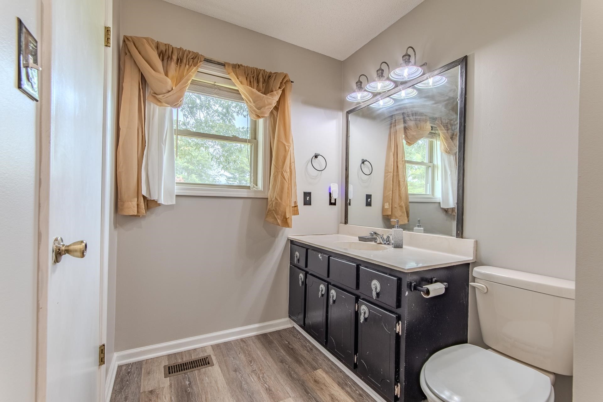 606 Duren Drive Adamsville, TN 38310 - Photo 28 of 40 a bathroom with a toilet a sink and a mirror