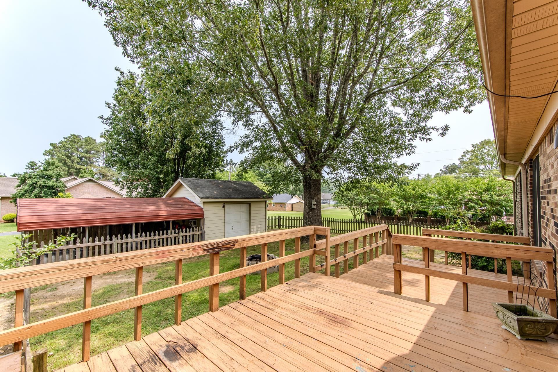 606 Duren Drive Adamsville, TN 38310 - Photo 33 of 40 a view of a deck with chairs and wooden fence