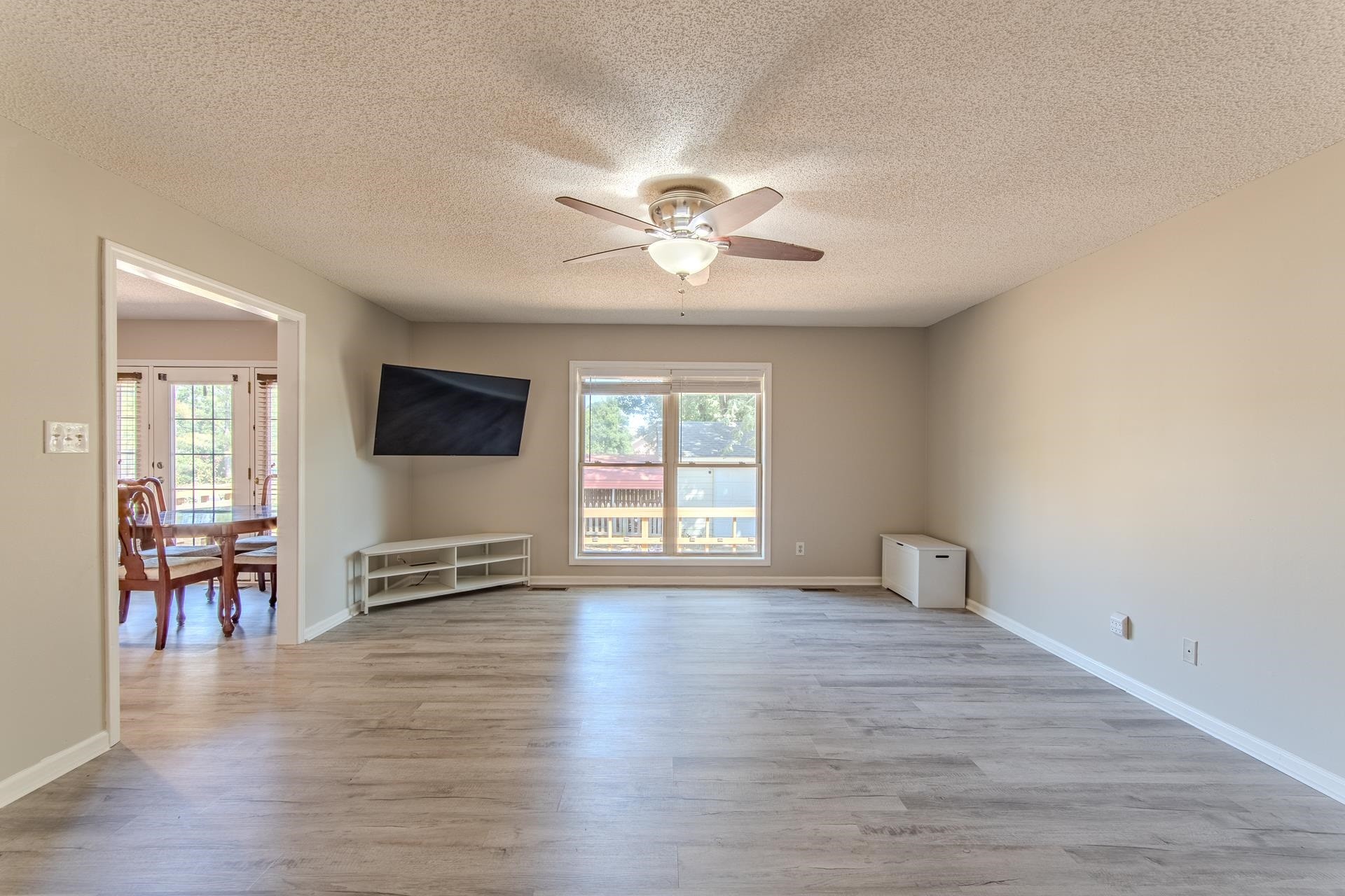 606 Duren Drive Adamsville, TN 38310 - Photo 8 of 40 wooden floor in an empty room with a window
