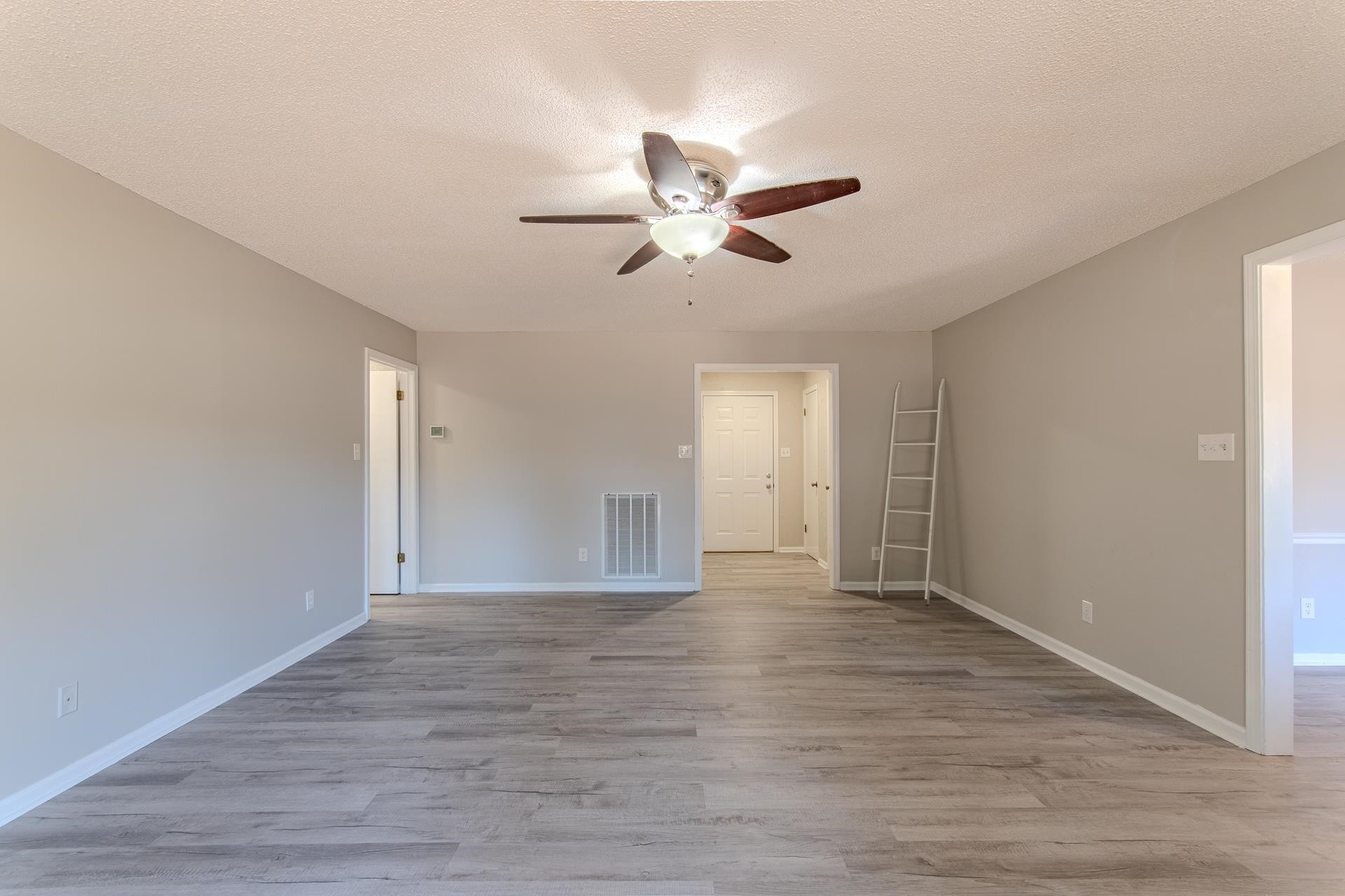 606 Duren Drive Adamsville, TN 38310 - Photo 10 of 40 a view of empty room with wooden floor and fan