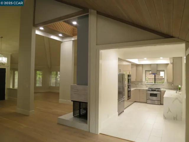 a view of a hallway with dining area and chandelier
