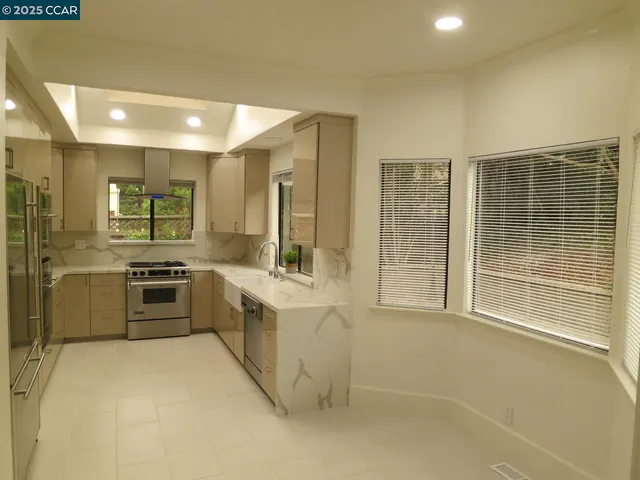 a large kitchen with cabinets and stainless steel appliances