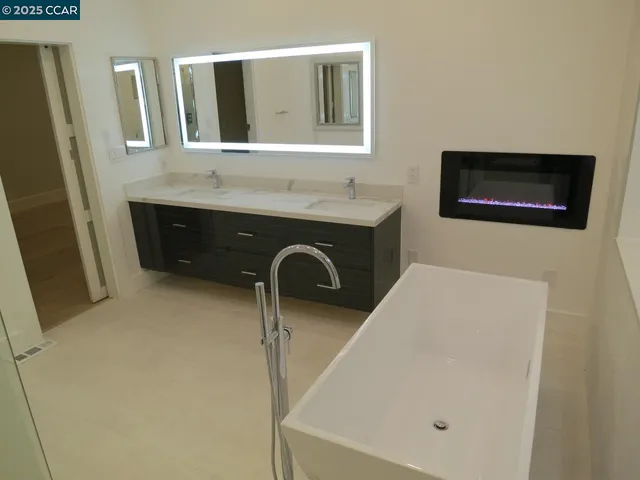 a bathroom with a sink a mirror and bathtub