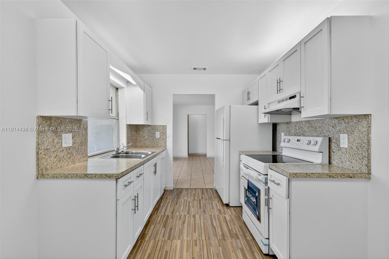 5331 Belleville Road West Palm Beach, FL 33417 - Photo 27 of 49 a kitchen with stainless steel appliances granite countertop a stove a sink and a refrigerator