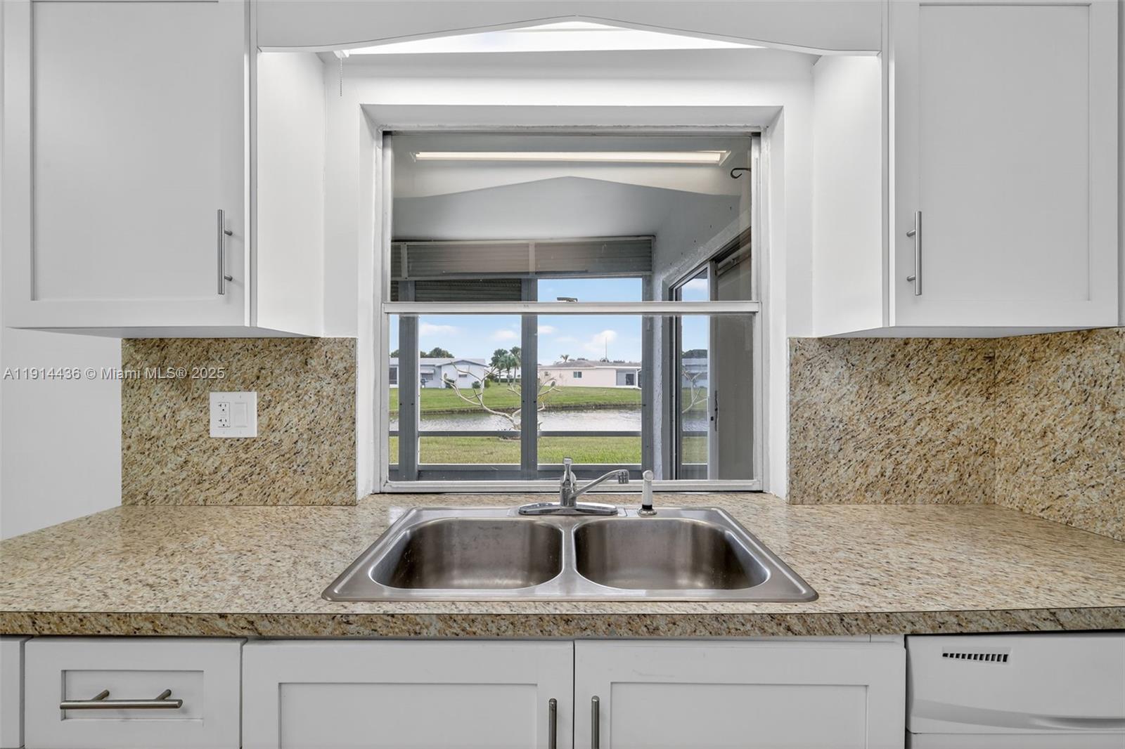 5331 Belleville Road West Palm Beach, FL 33417 - Photo 29 of 49 a kitchen with granite countertop a sink and a window