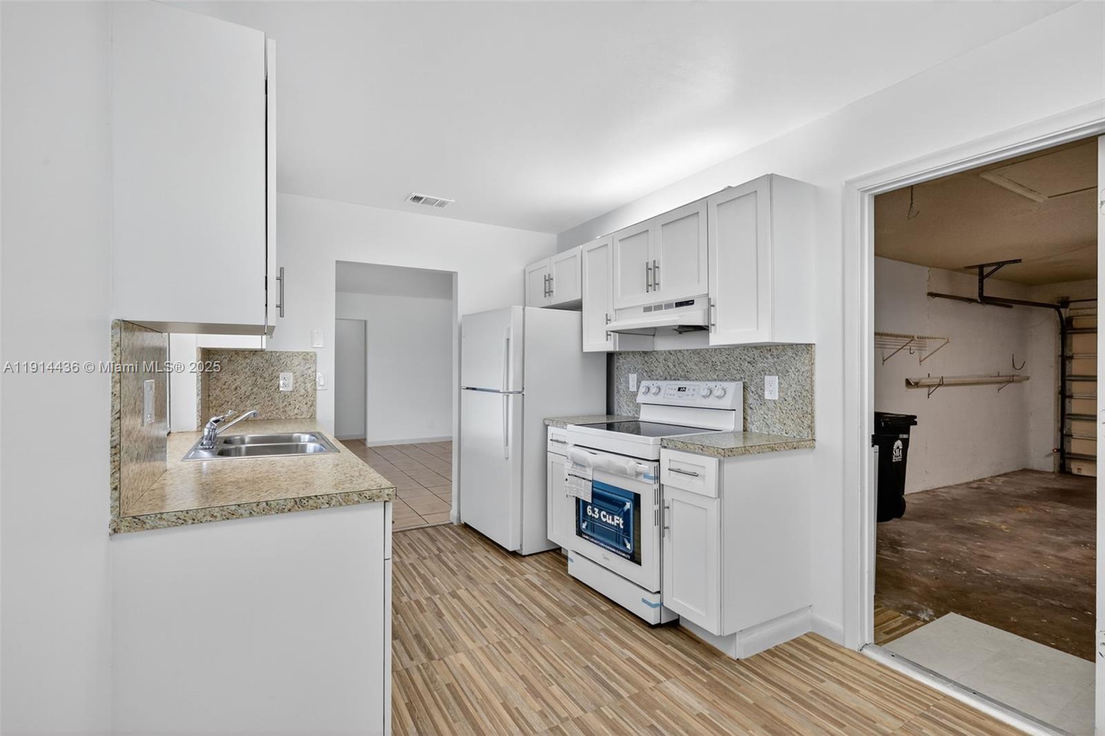 5331 Belleville Road West Palm Beach, FL 33417 - Photo 31 of 49 a kitchen with a stove and a refrigerator