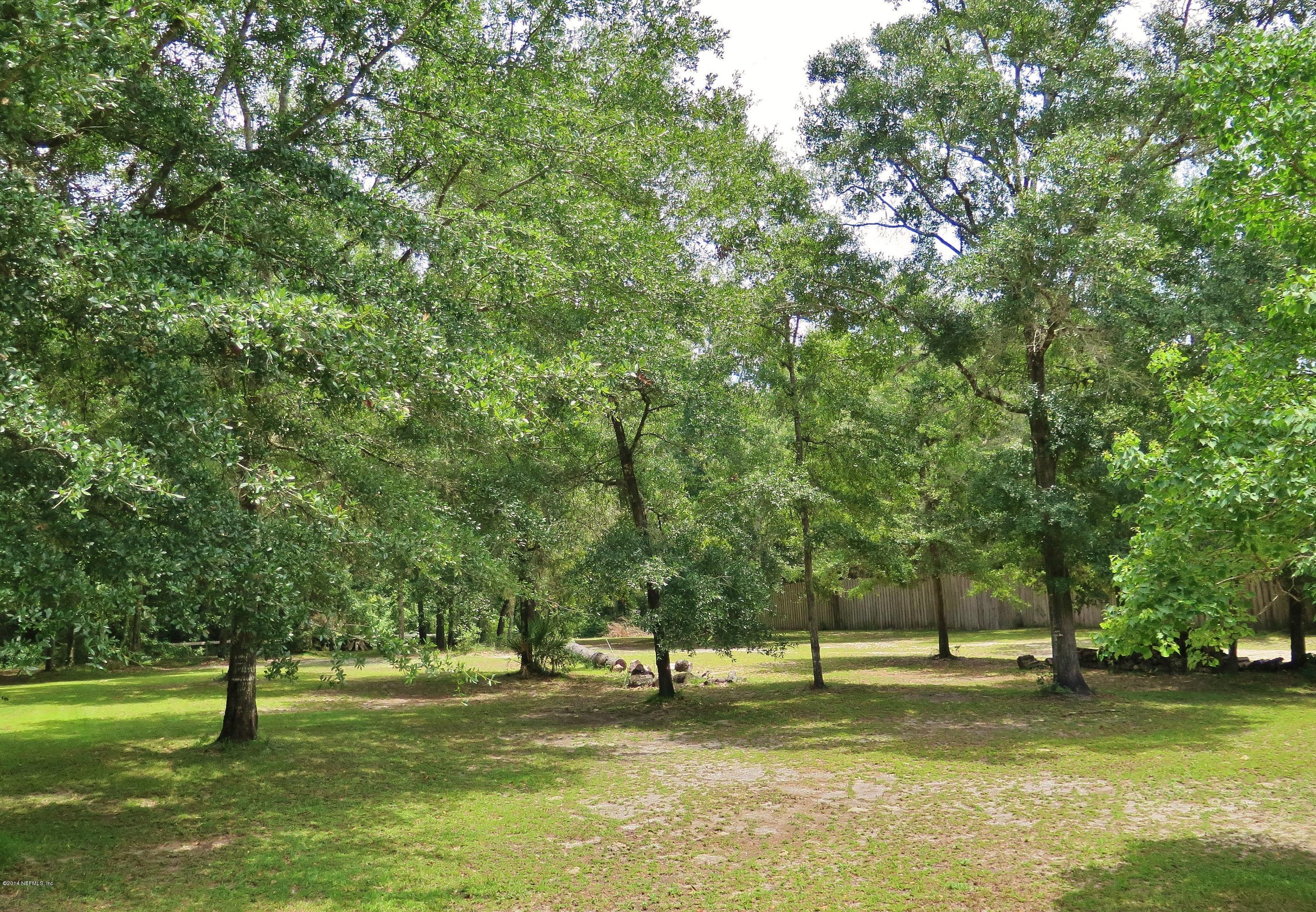 1395 Wedgewood Road St. Johns, FL 32259 - Photo 3 of 18 a swimming pool with trees in the background