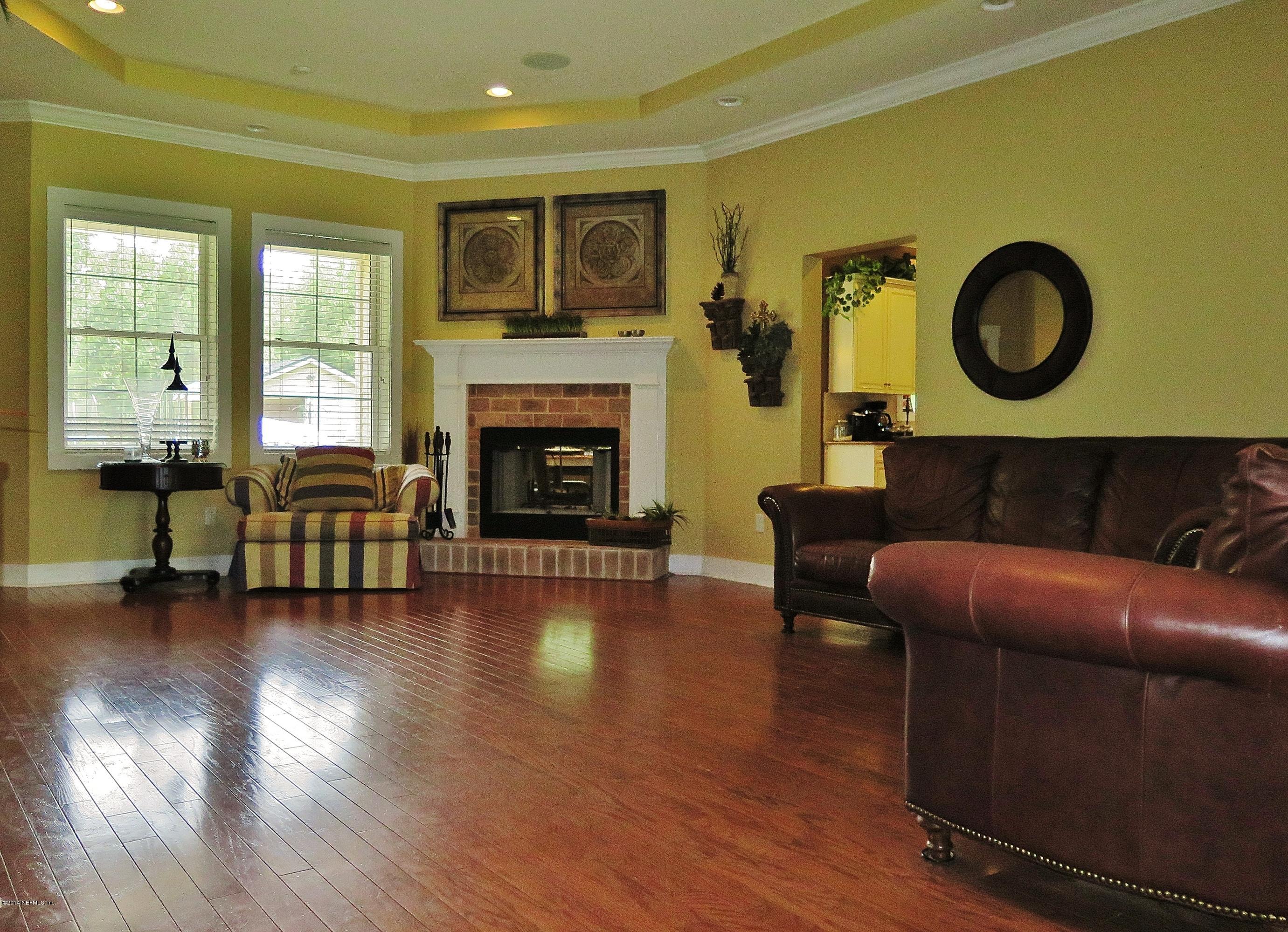 1395 Wedgewood Road St. Johns, FL 32259 - Photo 8 of 18 a living room with furniture and a fireplace