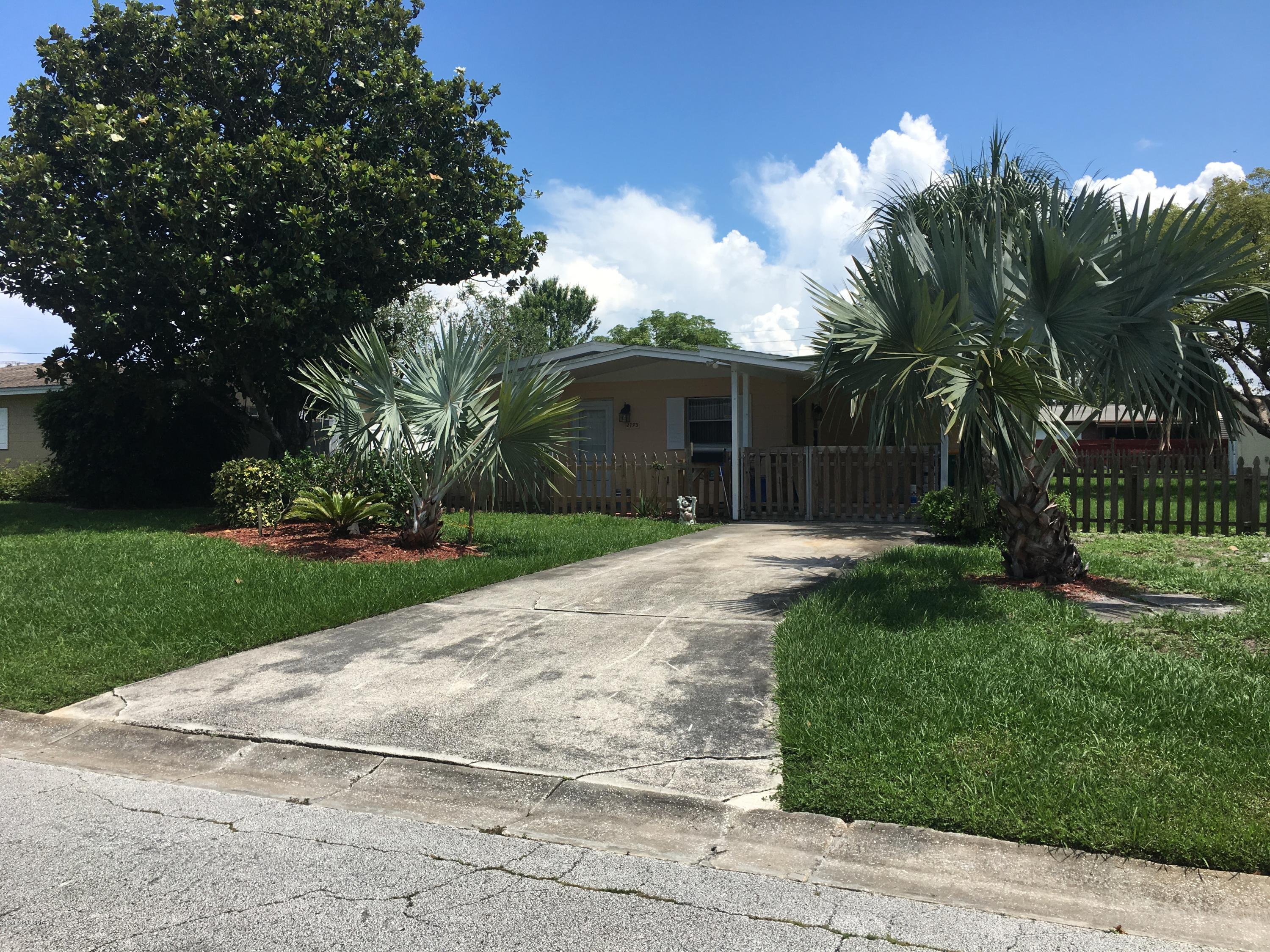 2793 Breeze Ridge Road Melbourne, FL 32935 - Photo 1 of 15 a front view of a house with a yard and a garage