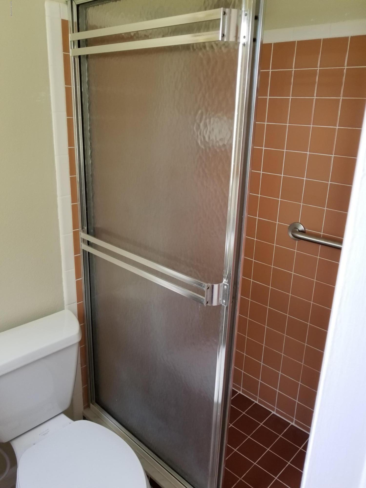 2793 Breeze Ridge Road Melbourne, FL 32935 - Photo 12 of 15 a bathroom with a toilet and a shower