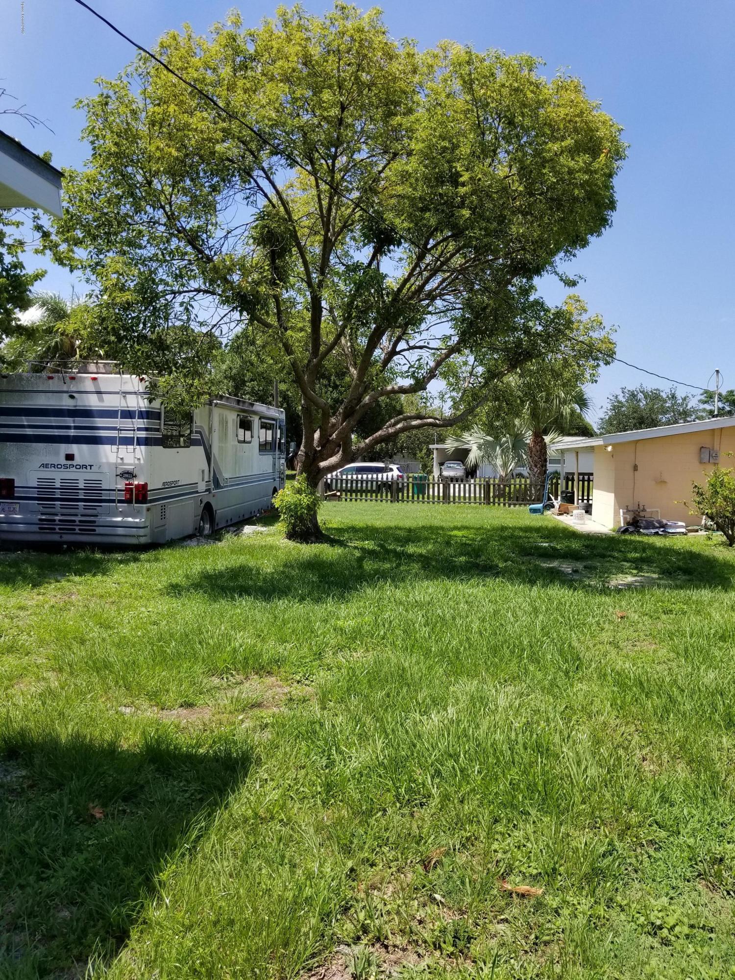 2793 Breeze Ridge Road Melbourne, FL 32935 - Photo 14 of 15 a view of a house with a backyard