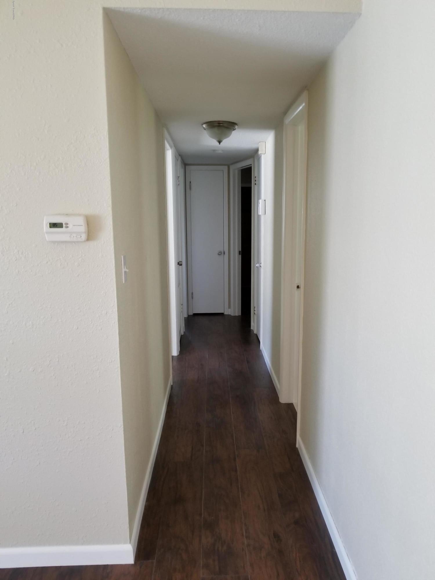 2793 Breeze Ridge Road Melbourne, FL 32935 - Photo 7 of 15 a view of a hallway with wooden floor