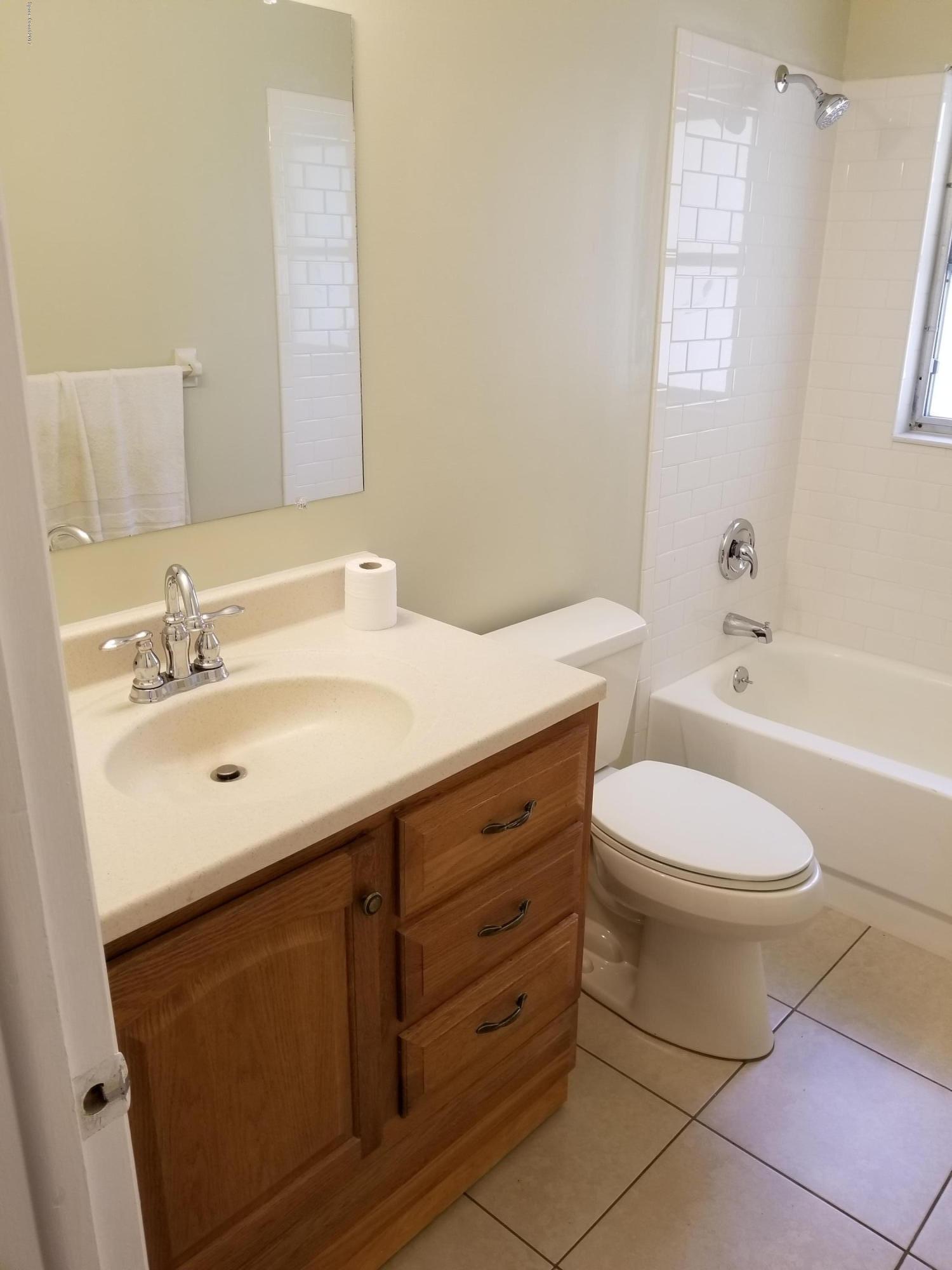 2793 Breeze Ridge Road Melbourne, FL 32935 - Photo 9 of 15 a bathroom with a sink toilet vanity and bathtub